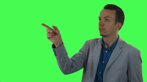 Businessman interacting with invisible touchscreen, isolated on green screen Stock Footage 309858551