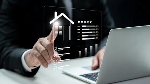 A businessman interacts with a digital screen displaying property ratings, .. Stock Photos