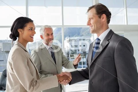 Businessman introducing a colleague Stock Photos