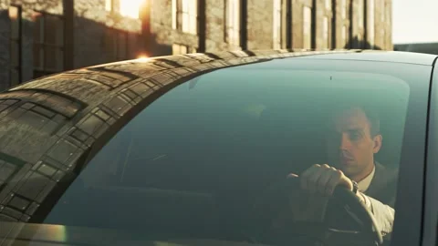 A businessman in a jacket drives an expensive car to work in the office Stock Footage 201284754