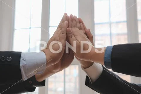 Businessman joining united hand, business team touching hands together after Stock Photos