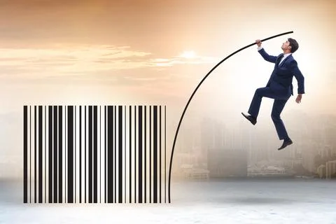 Businessman jumping over bar code in pole vaulting Foto stock