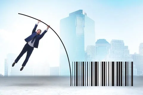 Businessman jumping over bar code in pole vaulting Foto stock