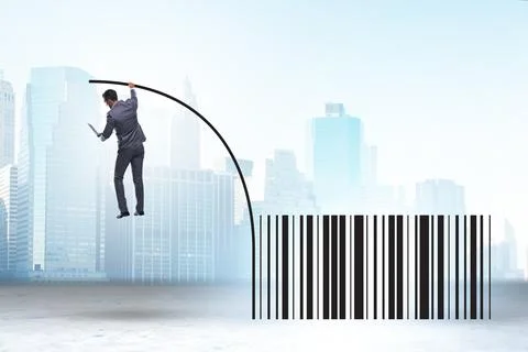 Businessman jumping over bar code in pole vaulting Foto stock