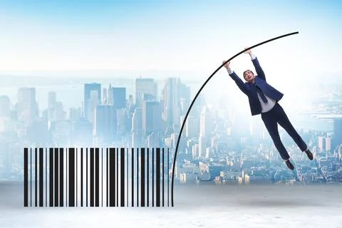 Businessman jumping over bar code in pole vaulting Foto stock