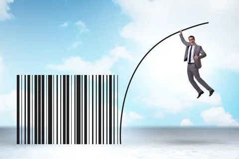 Businessman jumping over bar code in pole vaulting 写真素材