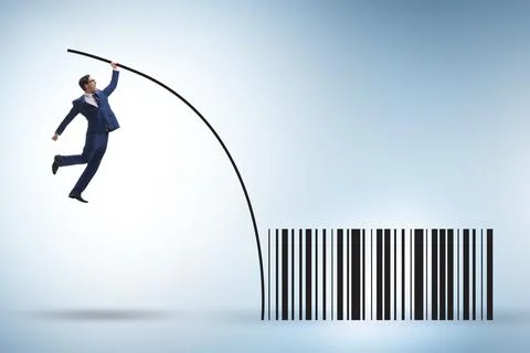 Businessman jumping over bar code in pole vaulting Foto stock
