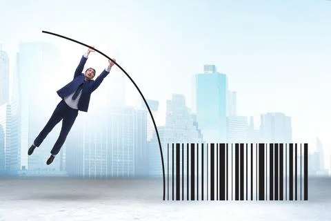 Businessman jumping over bar code in pole vaulting 写真素材