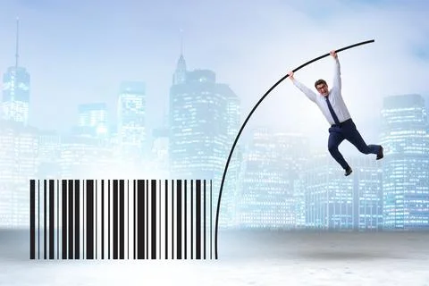 Businessman jumping over bar code in pole vaulting Foto stock