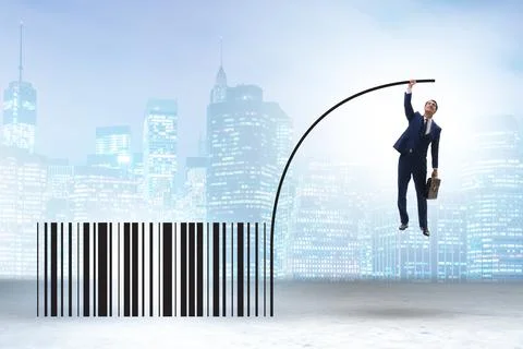 Businessman jumping over bar code in pole vaulting 写真素材