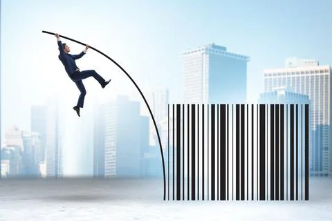 Businessman jumping over bar code in pole vaulting 写真素材