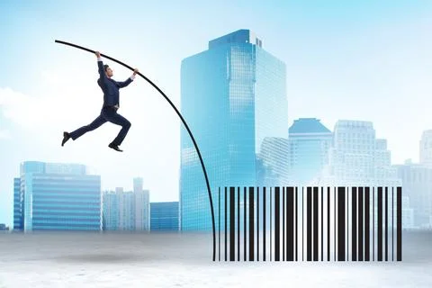 Businessman jumping over bar code in pole vaulting 写真素材