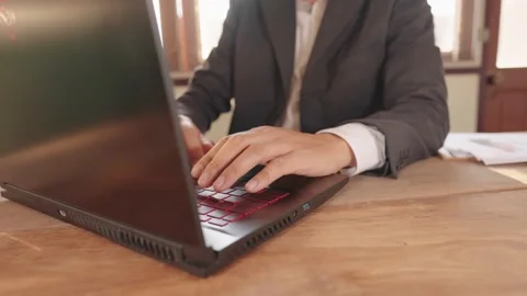 Businessman key data into laptop Stock-Footage 148101432