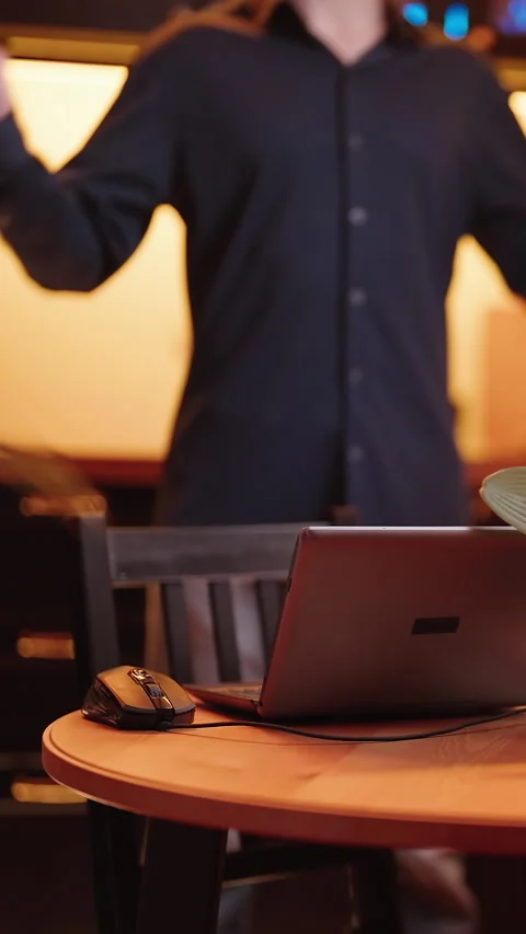Businessman in kitchen with laptop doing flexibility exercises Stock Footage 324961308
