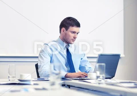 Businessman with laptop working in office Stock Photos