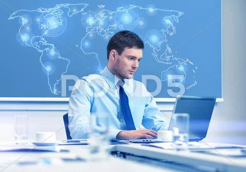Businessman with laptop working in office Stock Photos