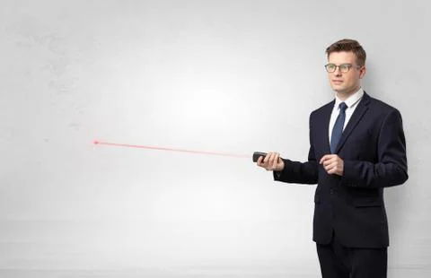 Businessman with laser pointer and copyspace white wall Stock Photos