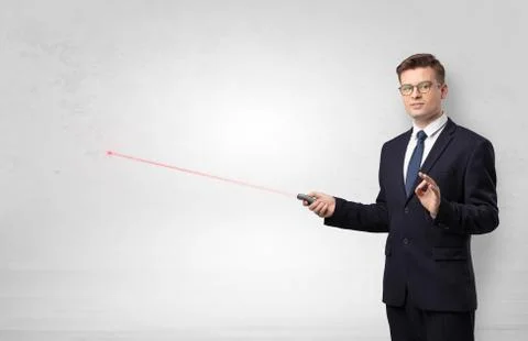 Businessman with laser pointer and copyspace white wall Stock Photos
