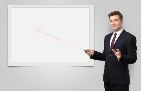 Businessman with laser pointer and copyspace white blackboard Stock Photos