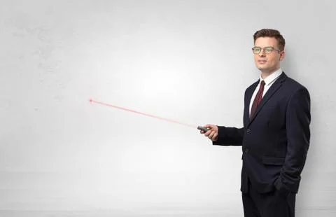 Businessman with laser pointer and copyspace white wall Stock Photos