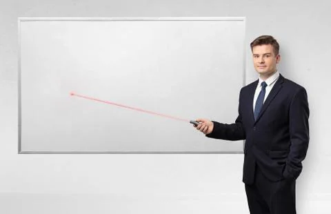 Businessman with laser pointer and copyspace white blackboard Stock Photos