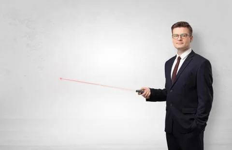 Businessman with laser pointer and copyspace white wall Stock Photos