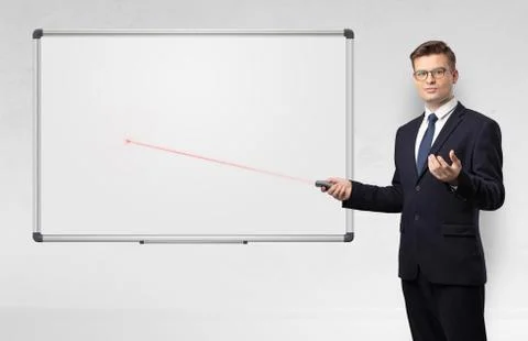 Businessman with laser pointer and copyspace white blackboard Stock Photos
