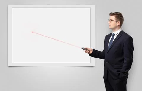 Businessman with laser pointer and copyspace white blackboard Stock Photos