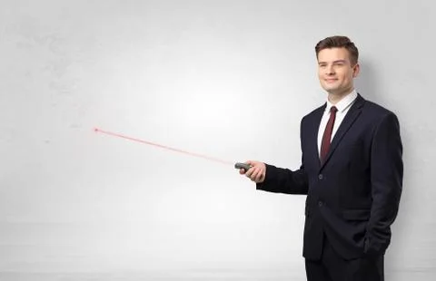 Businessman with laser pointer and copyspace white wall Stock Photos