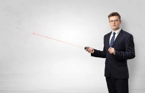 Businessman with laser pointer and copyspace white wall Stock Photos