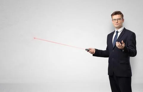 Businessman with laser pointer and copyspace white wall Stock Photos