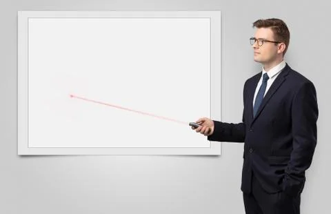 Businessman with laser pointer and copyspace white blackboard Stock Photos