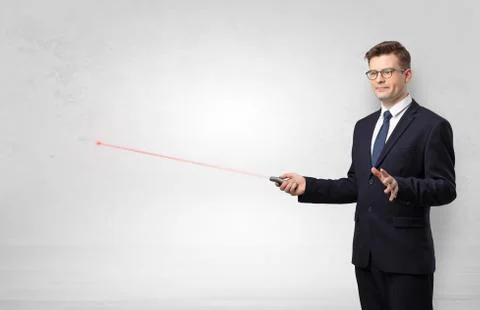 Businessman with laser pointer and copyspace white wall Stock Photos