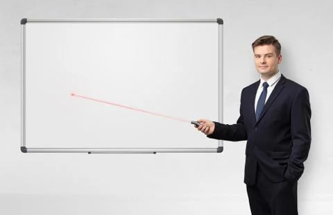 Businessman with laser pointer and copyspace white blackboard Stock Photos