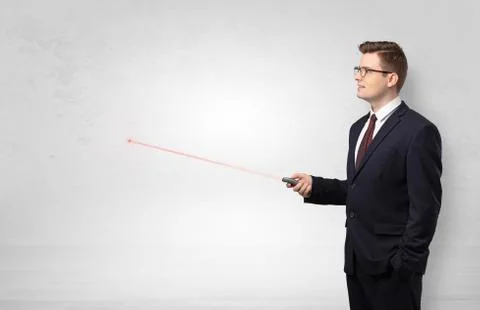 Businessman with laser pointer and copyspace white wall Stock Photos