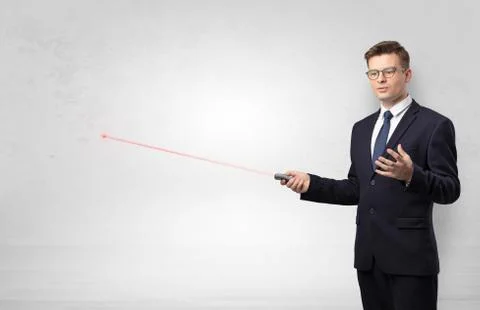 Businessman with laser pointer and copyspace white wall Stock Photos