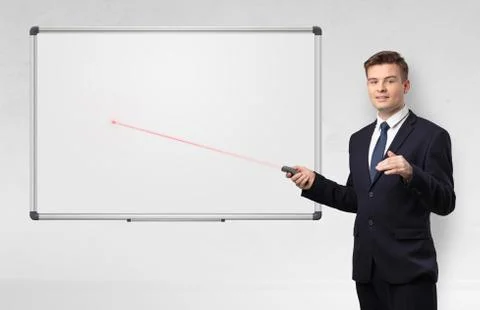 Businessman with laser pointer and copyspace white blackboard Stock Photos