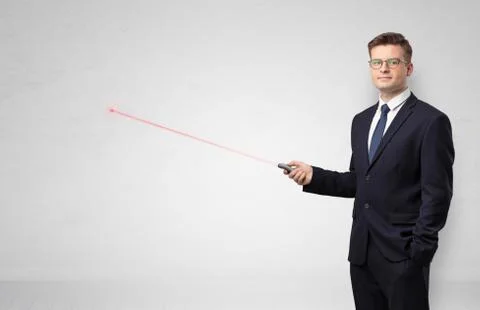 Businessman with laser pointer and copyspace white wall Stock Photos