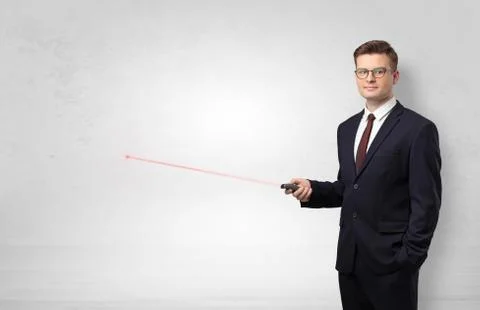 Businessman with laser pointer and copyspace white wall Stock Photos