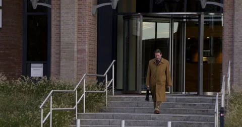 Businessman leaving office Stock Footage 57380752