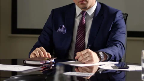Businessman listens and writes down important meeting points Stock Footage 243298778