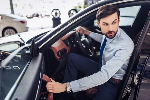 Businessman looking away while sitting in car Stock Photos