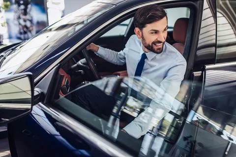 Businessman looking away while sitting in car Stock Photos
