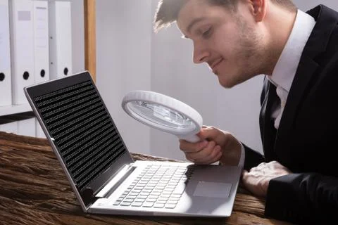 Businessman Looking At Binary Code With Magnifying Glass 스톡 사진