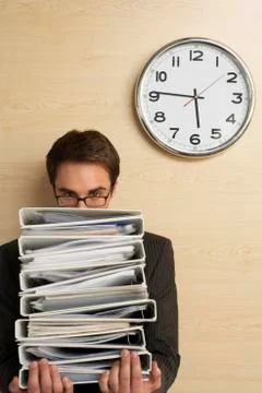 Businessman Looking At Clock On Wooden Wall Stock Photos