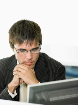 Businessman Looking At Computer In Office Stock Photos