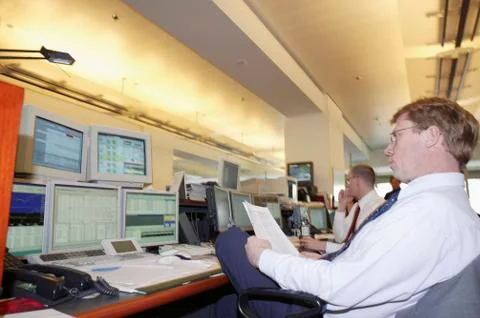 Businessman looking at computer screens Stock Photos
