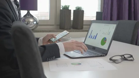 Businessman looking at data graphs on his compute Stock Footage 82723855