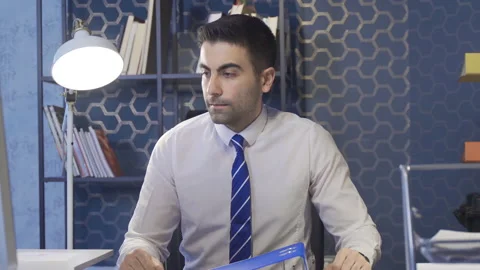 Businessman looking at documents from folder is tired and unhappy. Stock Footage 213546043