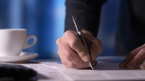 Businessman looking at documents signing paperwork in office at desk Stock Footage 54934732